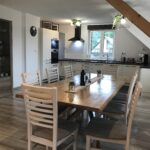 Dining table and kitchen in the background