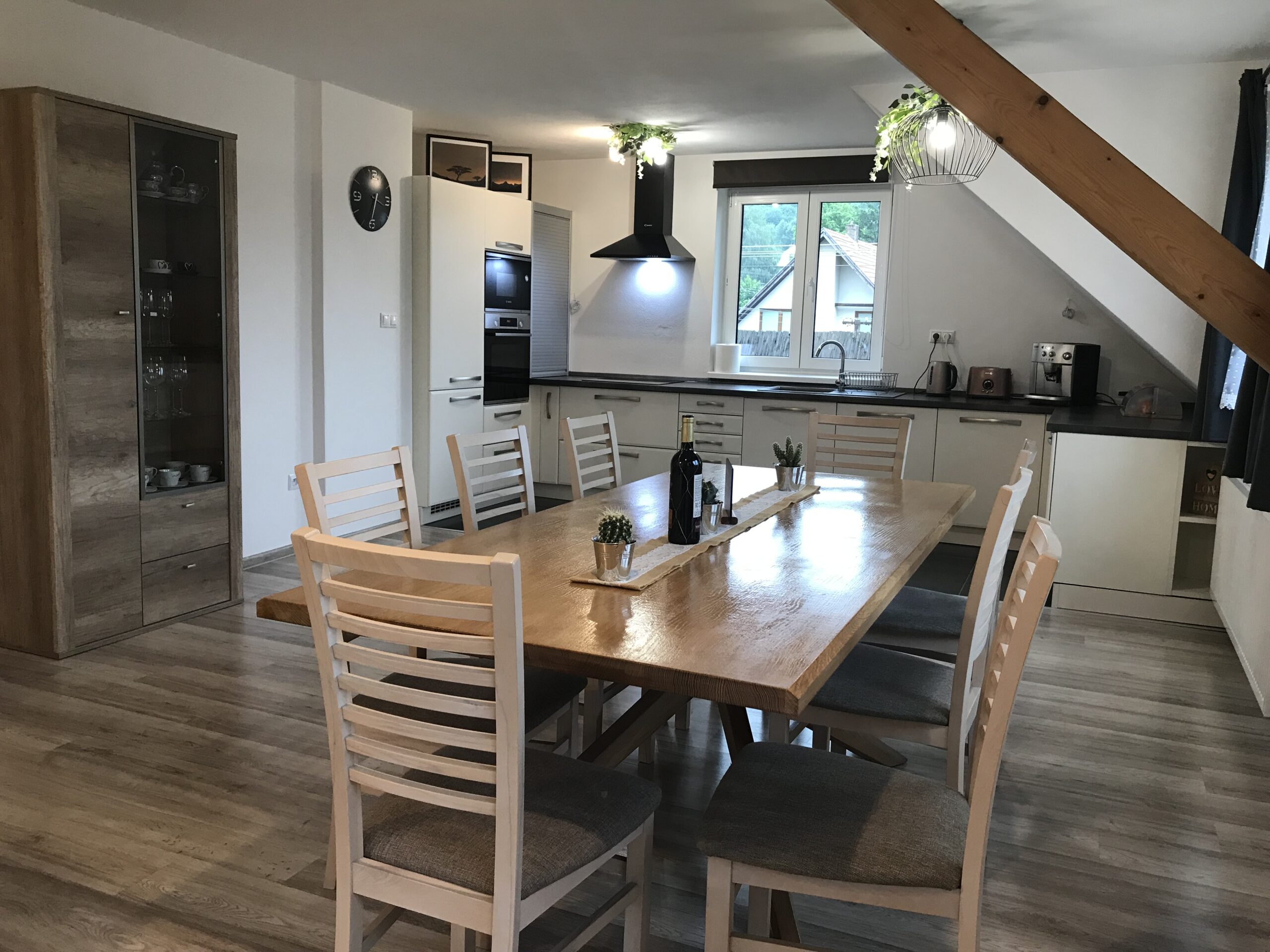 Dining table and kitchen in the background